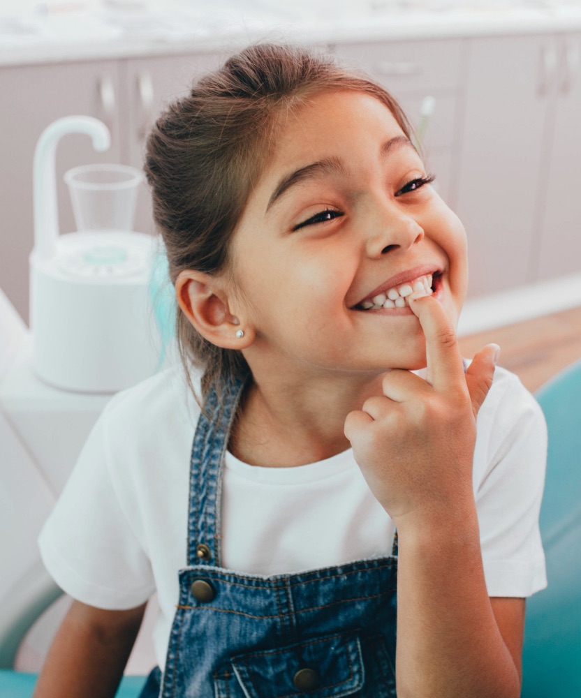 Child patient smiling in dental chair