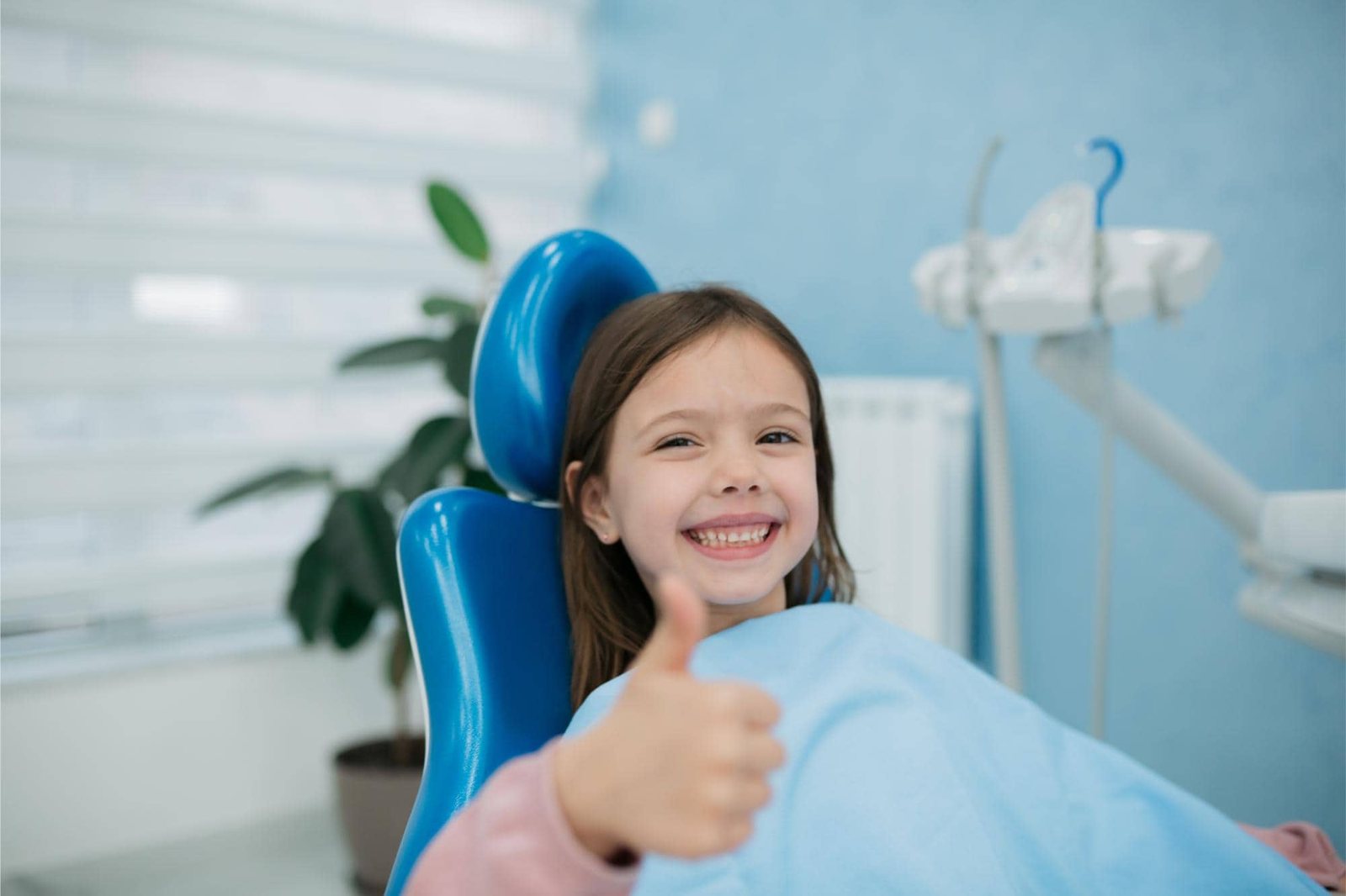 Young patient giving a thumbs up in the orthodontic chair